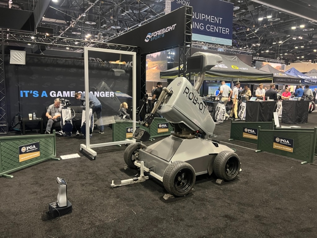 Rob-OT on the Foresight Sports trade-show floor with PGA Show branded barricades