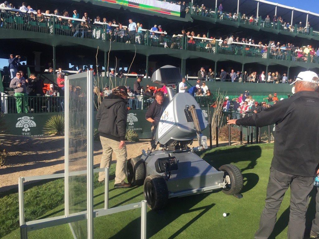 LDRIC on the tee at TPC Scottsdale's stadium 16th hole with the crowd looking on